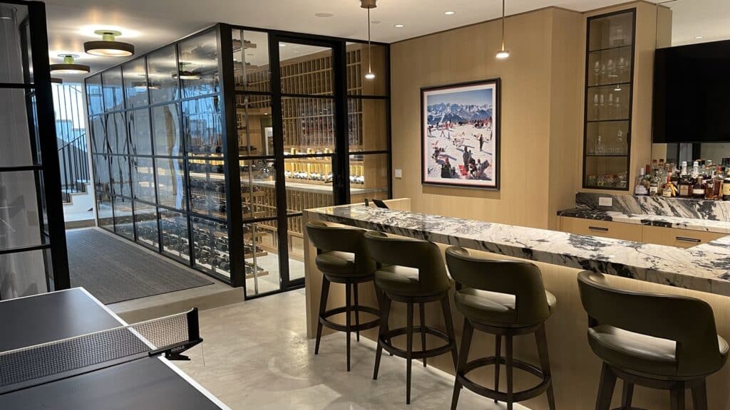 Modern Orange County home wine cellar with dual-paned glass doors and custom metal and wooden racking.