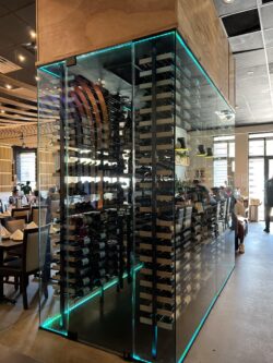 44 - This glass wine cellar is strategically located at the center of this restaurant , giving guests a full view of the collection wherever they sit. photo of commercial glass wine cellar in 1618 Asian Fusion restaurant