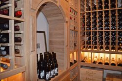 Wine Cellar Design with Traditional Approach and an Arch Wine Bottle Display