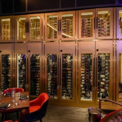 1 - Everything you see in this restaurant wine cellar design was custom-made by our team. photo of a modern restaurant wine cellar design in Orange County