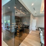 Even when your cellar is within a very bright room, frameless glass wine cellar doors can still effectively protect your wines by tinting them. Tinted frameless glass wine cellar door and enclosure