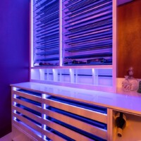 In this custom modern wine room, the RGB ribbon lights were integrated into the custom racking.