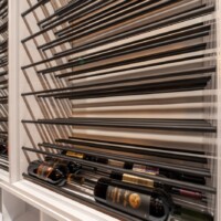 The upper racks with metal rods are triple-deep, which means 3x2 bottles can be stored per level.
