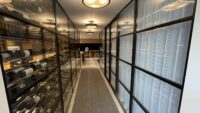 (2) Lining the hallway floor with a textured carpet enhanced the look of this modern glass wine cellar from outside.