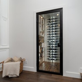 Glass wine cellar door in a sleek black frame perfect for modern wine cellars.
