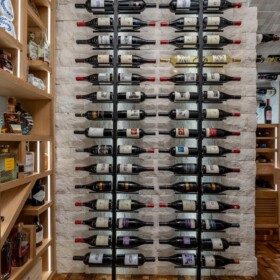 These metal wine racks are illuminated by LED lights behind the posts.