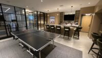 (4) The entrance to this modern glass wine cellar is a single, dual-paned glass door that swings inward.