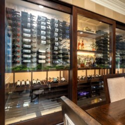 (2) Built into the wall, this carefully curated wine collection has become the heart of this dining area, elevating dinner parties and gatherings.