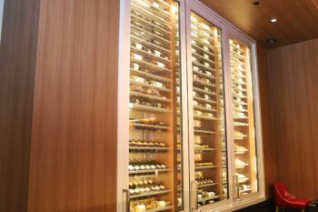 10 - A sophisticated Champagne Room wine display at Hell’s Kitchen in Harrah’s Hotel, illuminated with custom LED lighting.