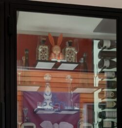 (8) A contemporary-style wine cellar for home with horizontal racking and dramatic shelving for spirits and glassware.