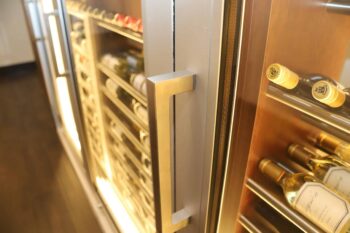 12 - Custom-built Champagne Room wine display by Cachet Wine Cellars with glowing LED accents.