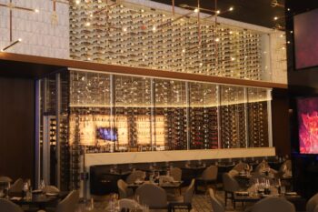 2 - Contemporary restaurant wine cellar with acrylic racking system in Hell's Kitchen in San Diego