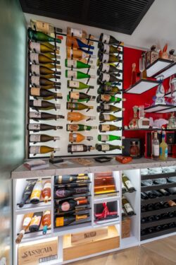(6) Tailored to collectors, this wine cellar for home keeps bottles organized and on full display beneath a marble tasting counter.