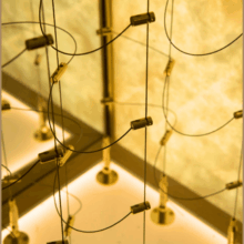 (7) Gold-bronze cable wine racks securely hold and store more than 200 bottles of wine in this cellar.